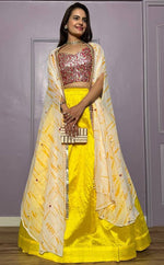 Striking Yellow Color Silk Fabric Party Wear Lehenga