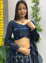 Dazzling Teal Color Jimmy Fabric Party Wear Lehenga