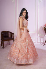 Charming Peach Color Net Fabric Party Wear Lehenga