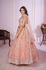 Charming Peach Color Net Fabric Party Wear Lehenga