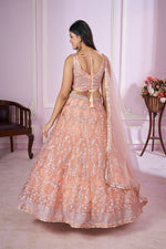 Charming Peach Color Net Fabric Party Wear Lehenga