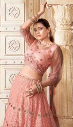 Magnetic Peach Color Net Fabric Party Wear Lehenga