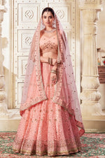 Magnetic Peach Color Net Fabric Party Wear Lehenga