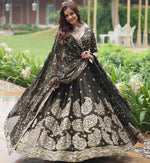 Magnetic Black Color Rangoli Fabric Party Wear Lehenga